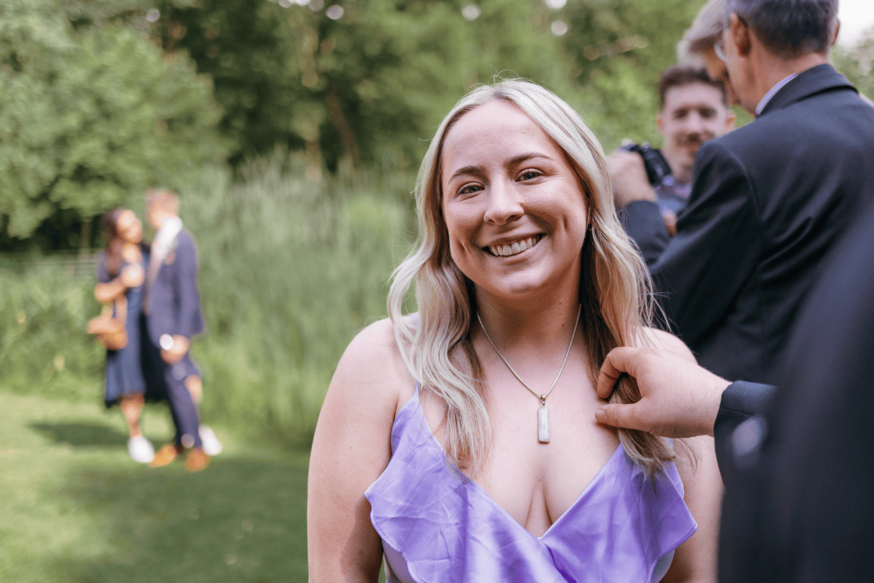 Lächelnde Frau im Freien bei einer Feier.