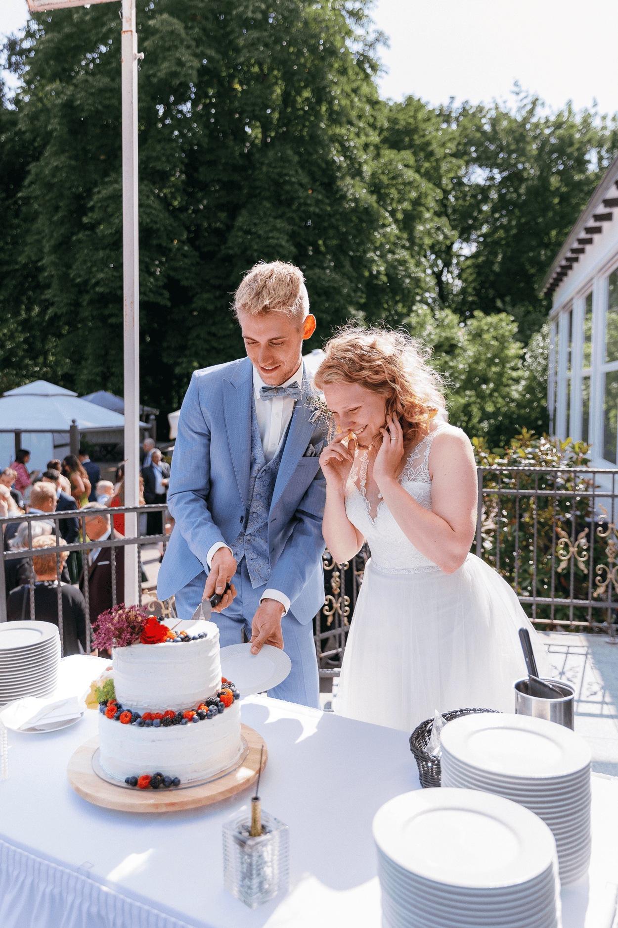 Brautpaar schneidet Hochzeitstorte an.